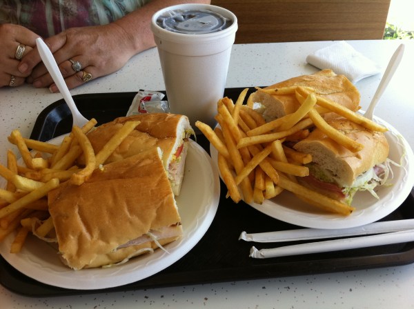 Two beautiful J's hoagies with fries. An Italian and my turkey hoagie, with Mom across the table.